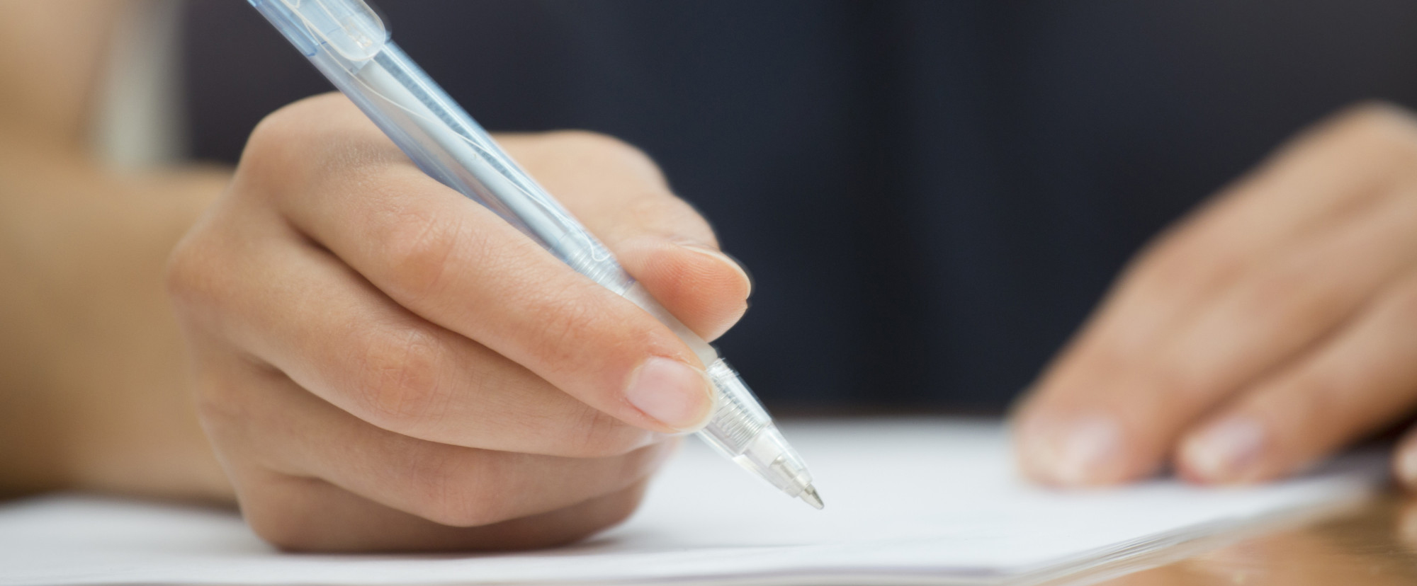 Woman writing with pen