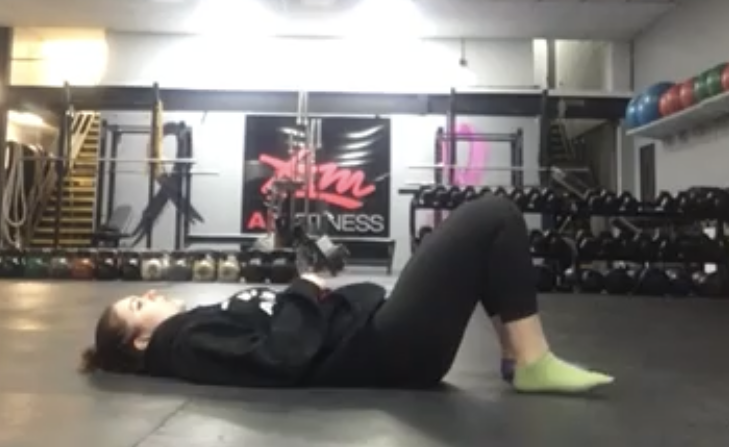 Woman exercising laying on the ground